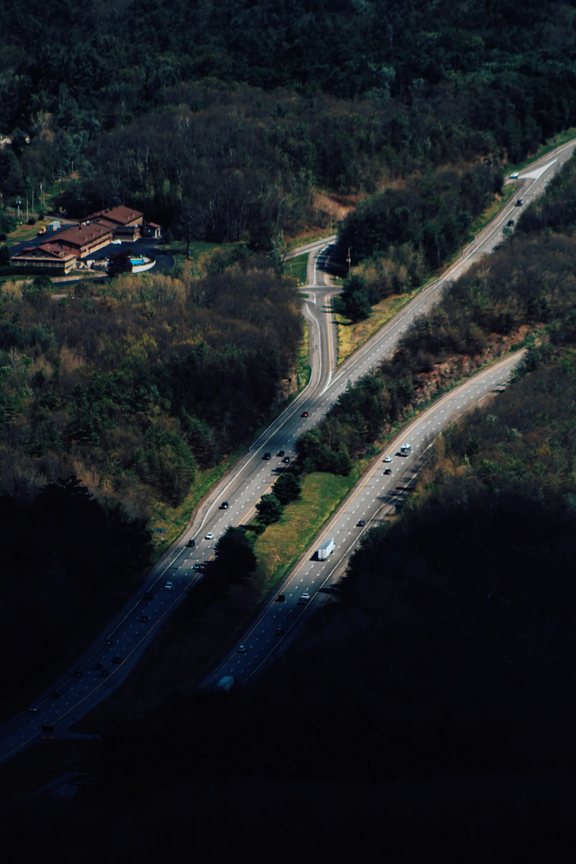Aerial drone shot of winding highways through green countryside