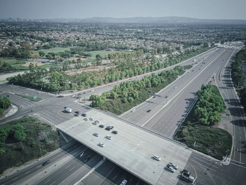 Aerial drone view of vehicles on a wide highway interchange