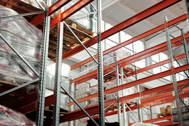 Bright modern warehouse with pallets and storage racks